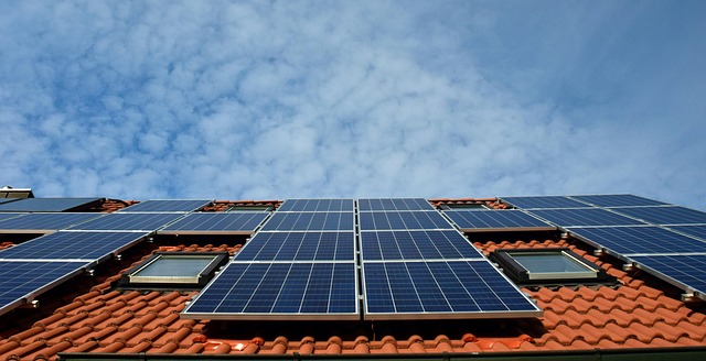 technician installing solar panel on canadian home roof with safety equipment